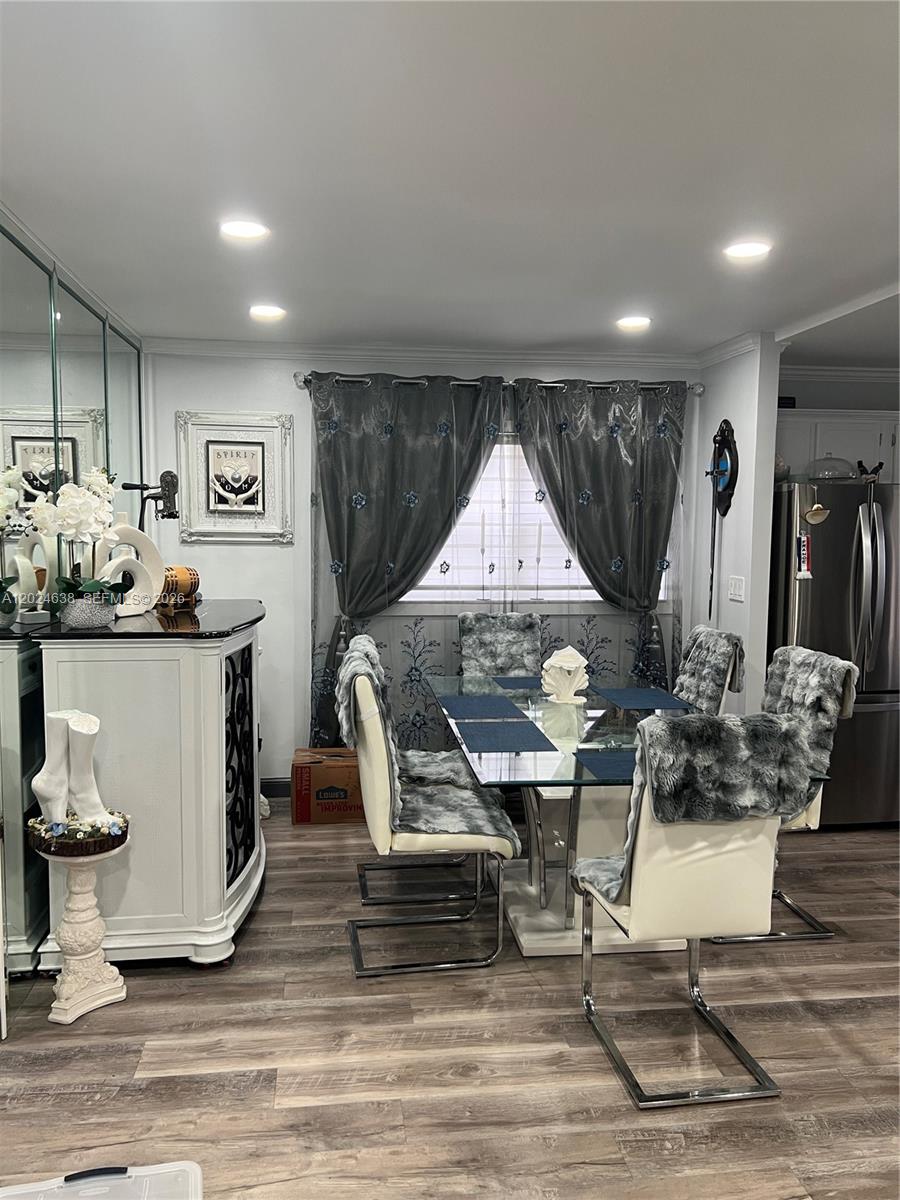 A dining area features a glass table, white chairs with faux fur covers, and gray curtains — 5300 Washington St # H140, Hollywood FL 33021, HOLLYWOOD, FL