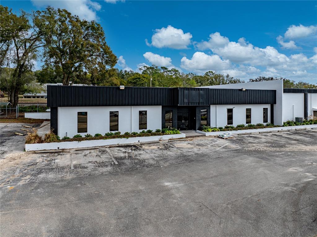 A single-story commercial building with a black metal roof and white exterior walls — 15552 US HIGHWAY 301, DADE CITY, FL