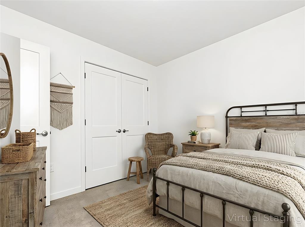 A bedroom features a metal bed frame, wooden dresser, wicker chair, and white double doors — 2022 EDUCATION STREET, ST CLOUD, FL
