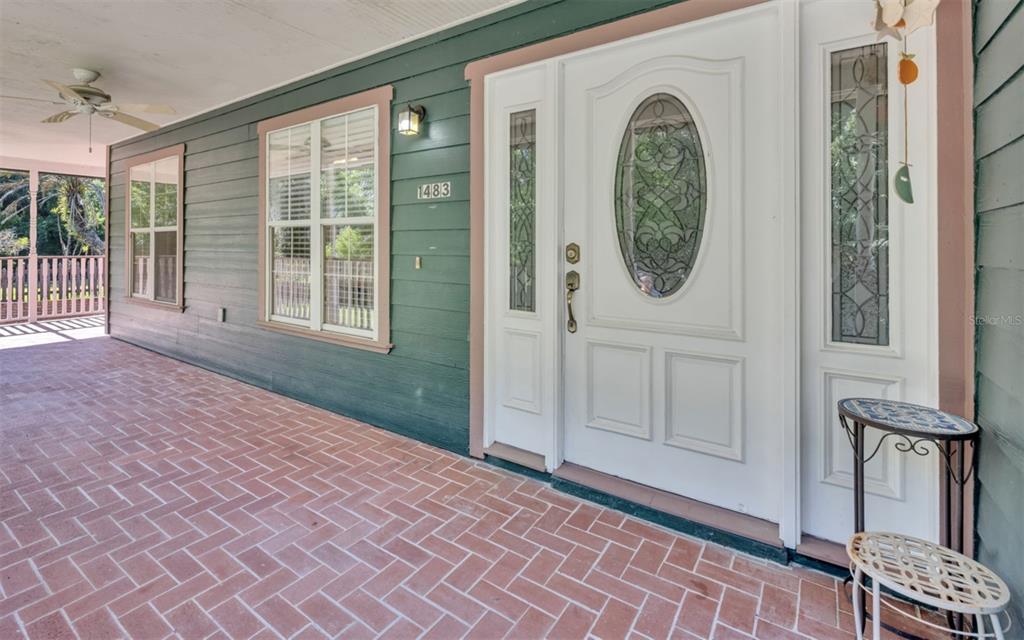 A two-story house with blue siding, a covered front porch, and brick steps — 1483 MIRKWOOD COVE, OVIEDO, FL