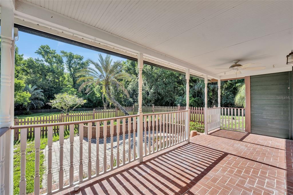 An aerial view of a small pond surrounded by dense trees and a grassy lawn — 1483 MIRKWOOD COVE, OVIEDO, FL