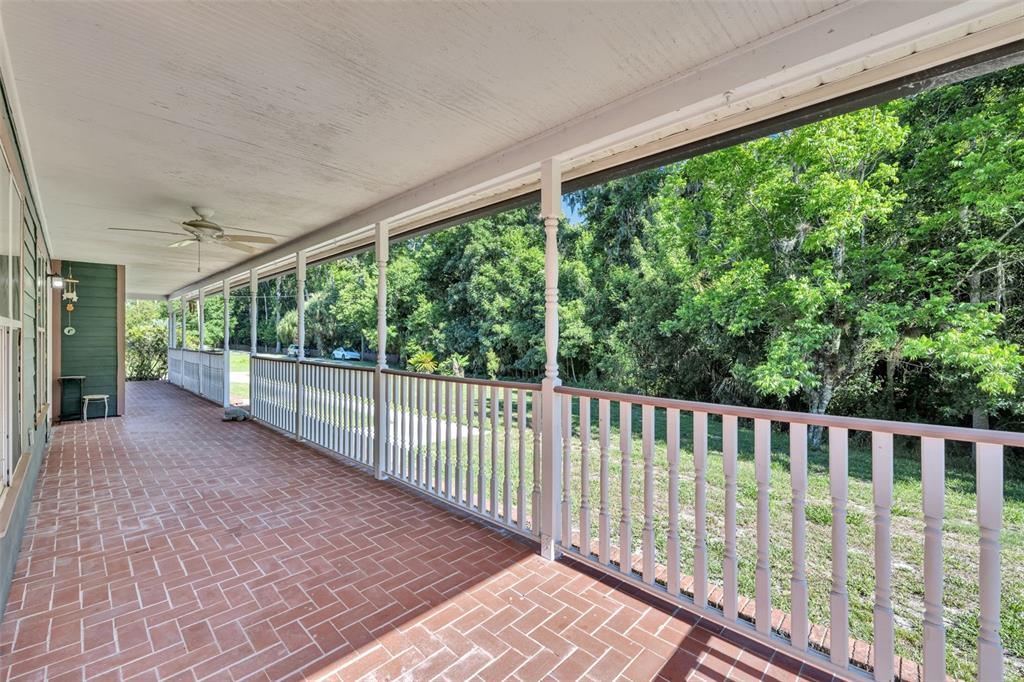 An aerial view shows a house and a small pond on a wooded lot — 1483 MIRKWOOD COVE, OVIEDO, FL