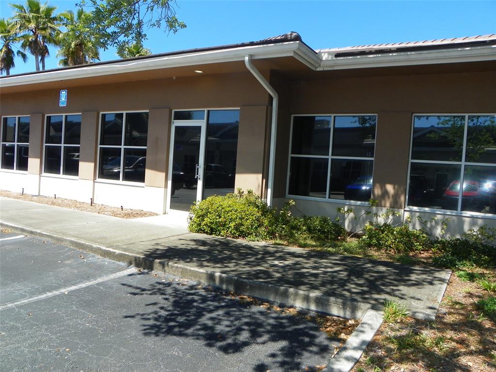 The exterior of a single-story commercial building features a glass entrance and large windows — 2824 MANATEE AVENUE E, BRADENTON, FL