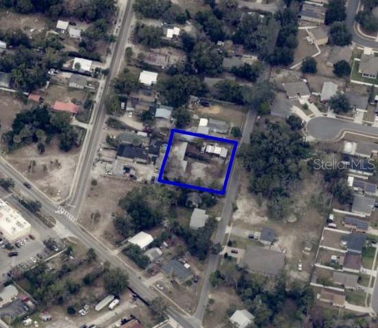 An aerial view shows a residential lot outlined in blue within a suburban neighborhood — 210 N NEW HAMPSHIRE AVENUE, APOPKA, FL