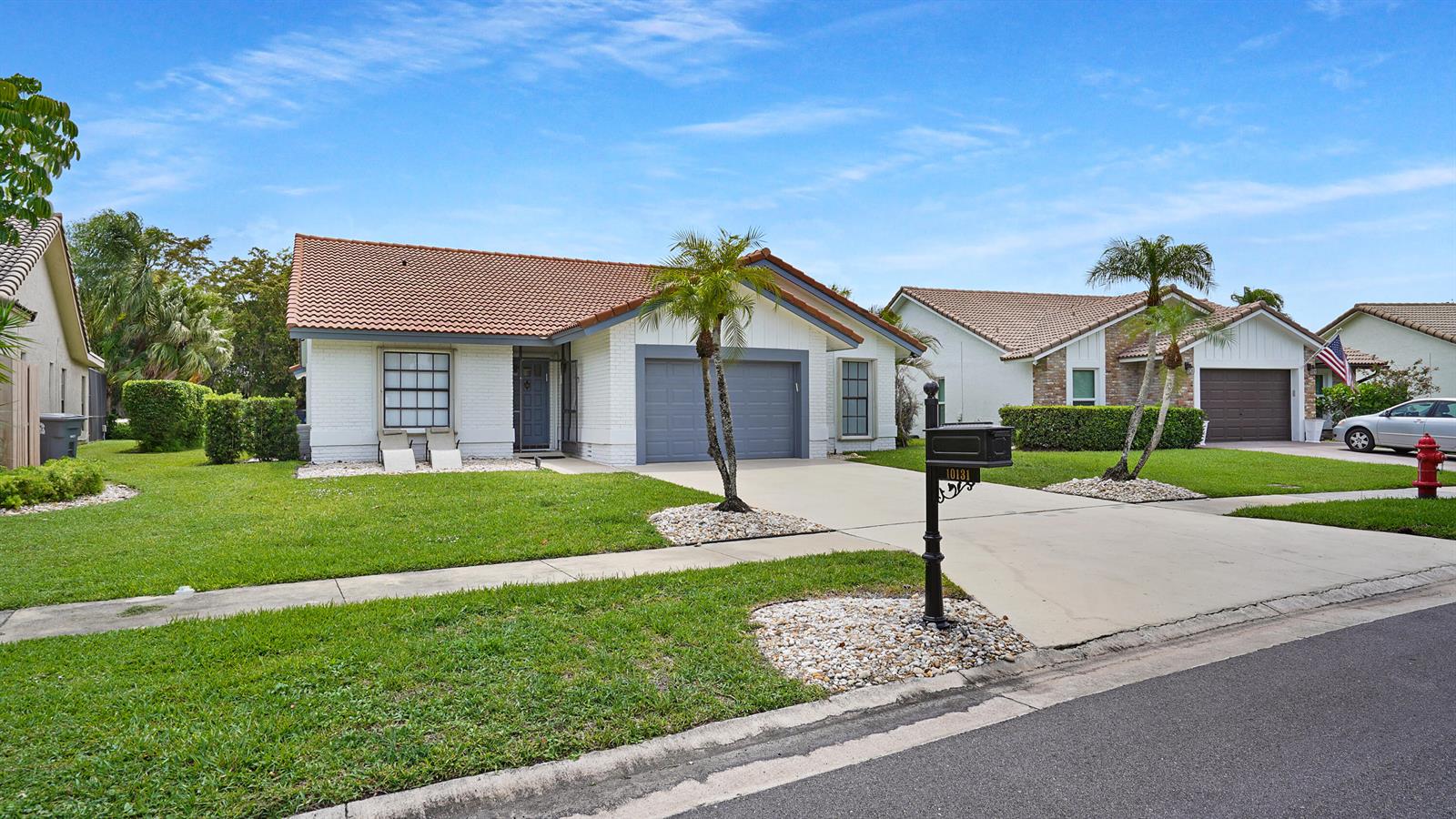 A white brick house with a tile roof, a two-car garage, and a front lawn — 10131 Camelback Lane, Boca Raton FL 33498, BOCA RATON, FL