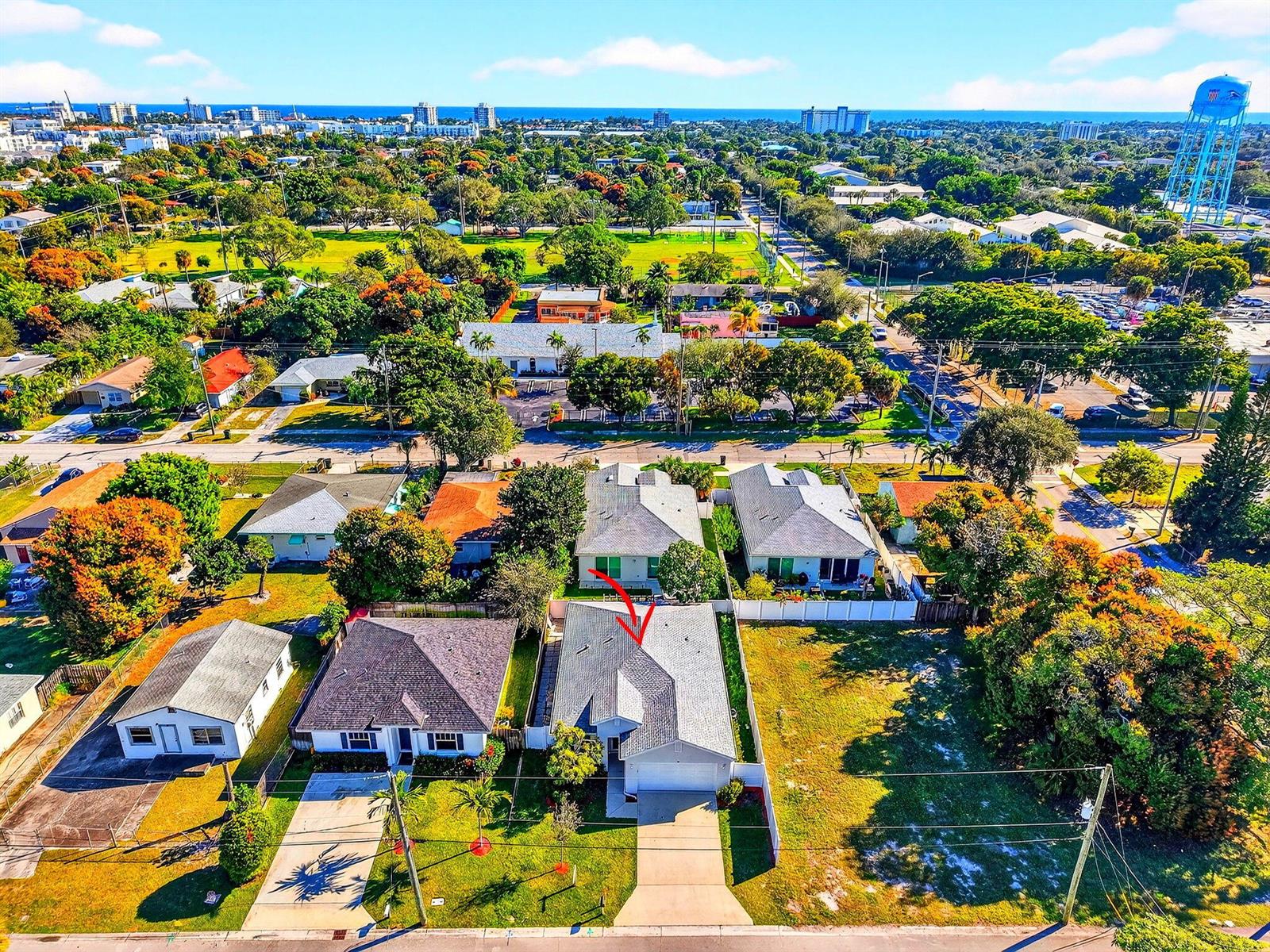 An aerial view shows a residential neighborhood with a red arrow pointing to a house — 341 Oak Alley, Delray Beach FL 33444, DELRAY BEACH, FL