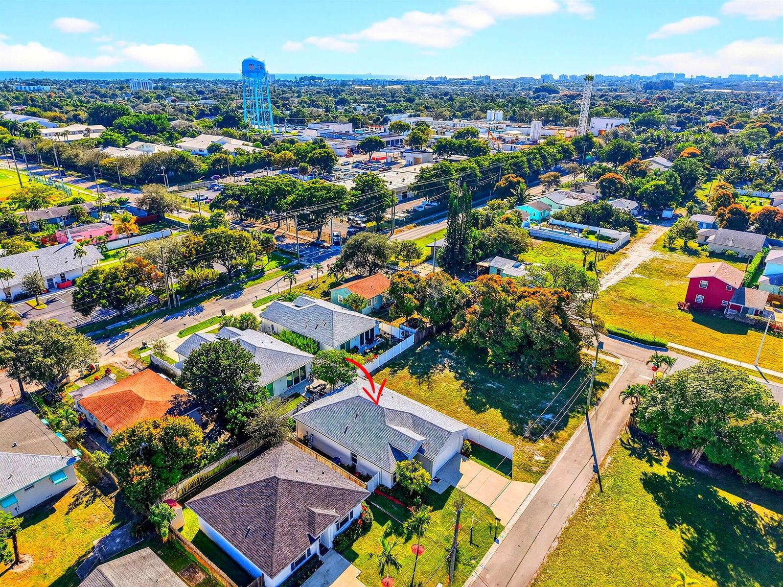 An aerial view shows a residential neighborhood with a red arrow pointing to a house — 341 Oak Alley, Delray Beach FL 33444, DELRAY BEACH, FL