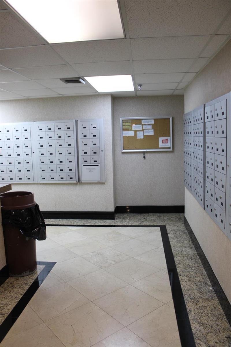 A mailroom features rows of metal mailboxes, a bulletin board, and tiled flooring — 1010 S Ocean Boulevard # 1214, Pompano Beach FL 33062, POMPANO BEACH, FL