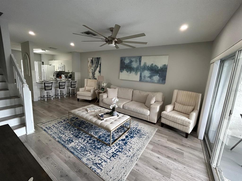 A living room with a sofa, two armchairs, a coffee table, and an open kitchen — 4629 SABAL KEY DRIVE UNIT 4629, BRADENTON, FL