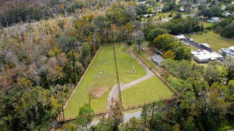 An aerial view shows two fenced, grassy parcels of land separated by a wooden fence — 6518 OLD TAMPA HIGHWAY UNIT A, DAVENPORT, FL
