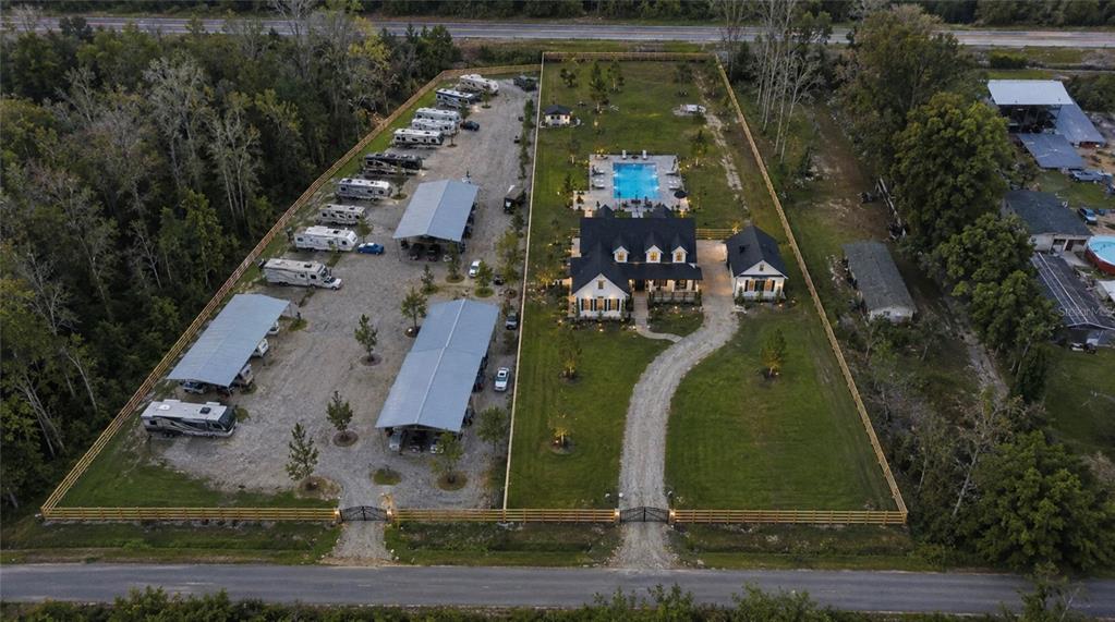 An aerial view shows a house with a pool and a large RV storage lot — 6518 OLD TAMPA HIGHWAY UNIT A, DAVENPORT, FL