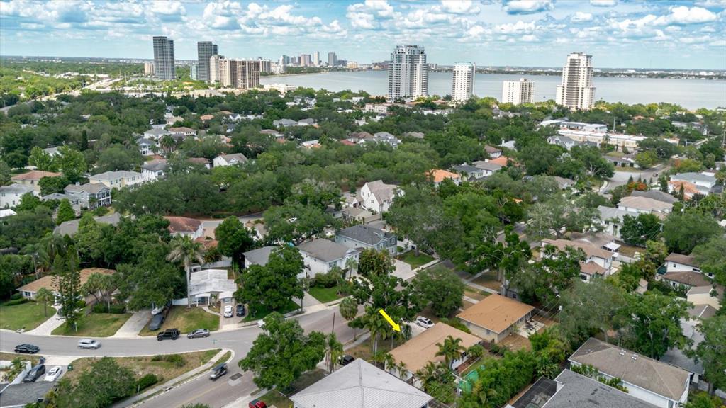 An aerial view shows a residential neighborhood with houses, trees, and a distant city skyline — 3138 W EUCLID AVENUE, TAMPA, FL