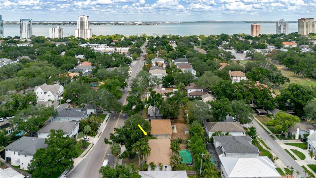 An aerial view shows a residential neighborhood with houses, trees, and a distant waterfront — 3138 W EUCLID AVENUE, TAMPA, FL