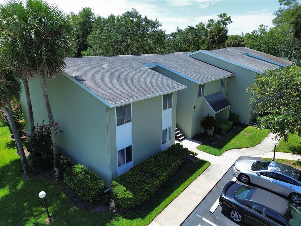 An aerial view of a two-story apartment building with a parking lot and landscaping — 600 FAIRWAYS CIRCLE UNIT B, OCALA, FL