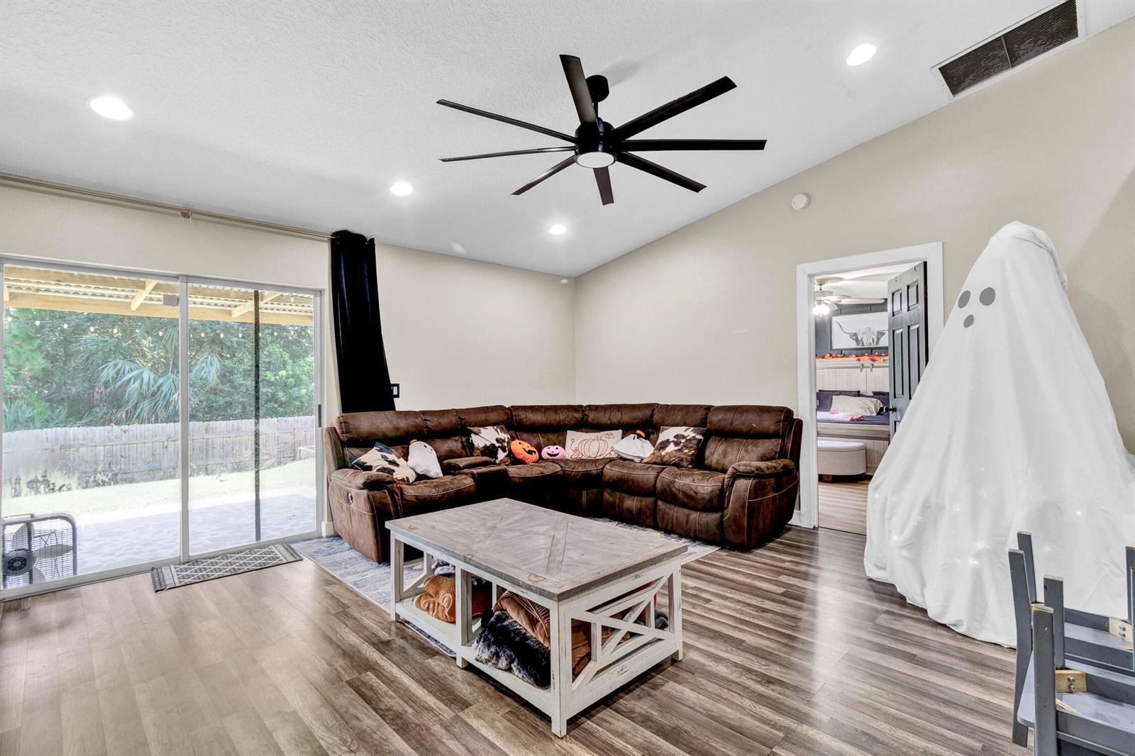 A single-story house with a gray stucco exterior, a two-car garage, and a concrete driveway — 7726 102nd Avenue, Vero Beach FL 32967, VERO BEACH, FL