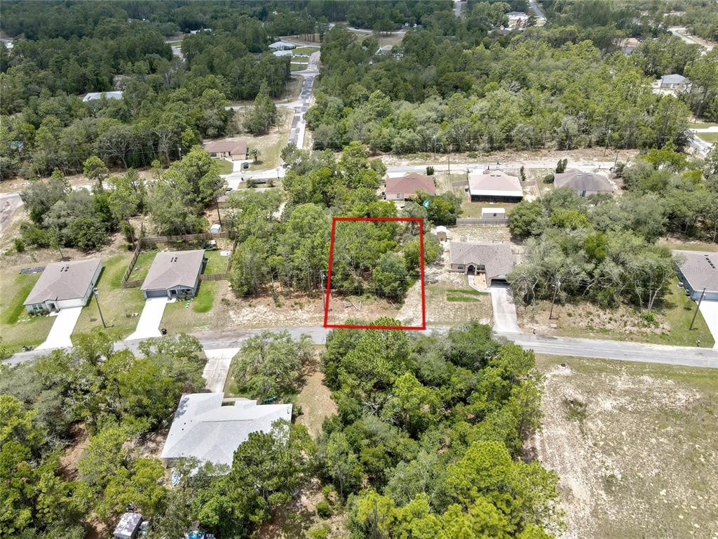 An aerial view shows a rectangular, wooded vacant lot outlined in red within a neighborhood — 9652 N SAN JOSE WAY, CITRUS SPRINGS, FL