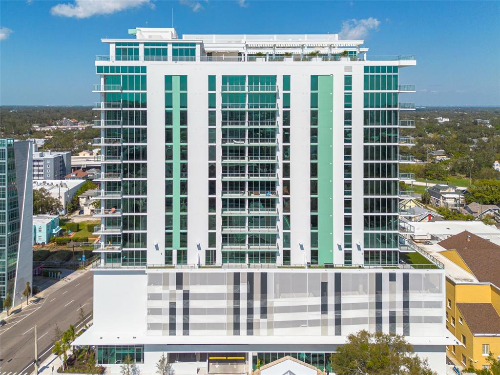 A modern high-rise apartment building features a white facade with extensive glass windows and balconies — 777 3RD AVENUE N UNIT 1104, ST PETERSBURG, FL