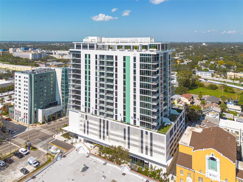 An aerial view of a modern high-rise apartment building with a parking garage base — 777 3RD AVENUE N UNIT 1104, ST PETERSBURG, FL