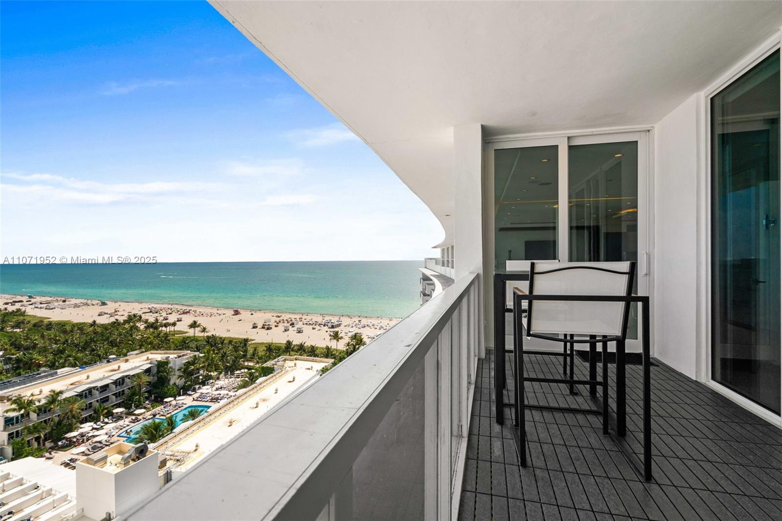 A balcony with outdoor seating overlooks a sandy beach and the ocean — 100 Lincoln Rd, Miami Beach FL 33139, MIAMI BEACH, FL