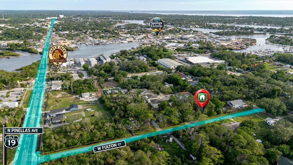This aerial view shows a residential property location marked with a pin near a highway — HIGHLAND AVENUE, TARPON SPRINGS, FL