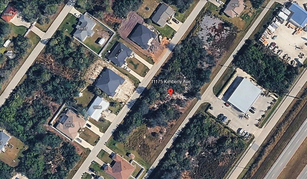 This aerial map shows a vacant lot situated between residential houses and a commercial building — 11175 KIMBERLY AVENUE, ENGLEWOOD, FL
