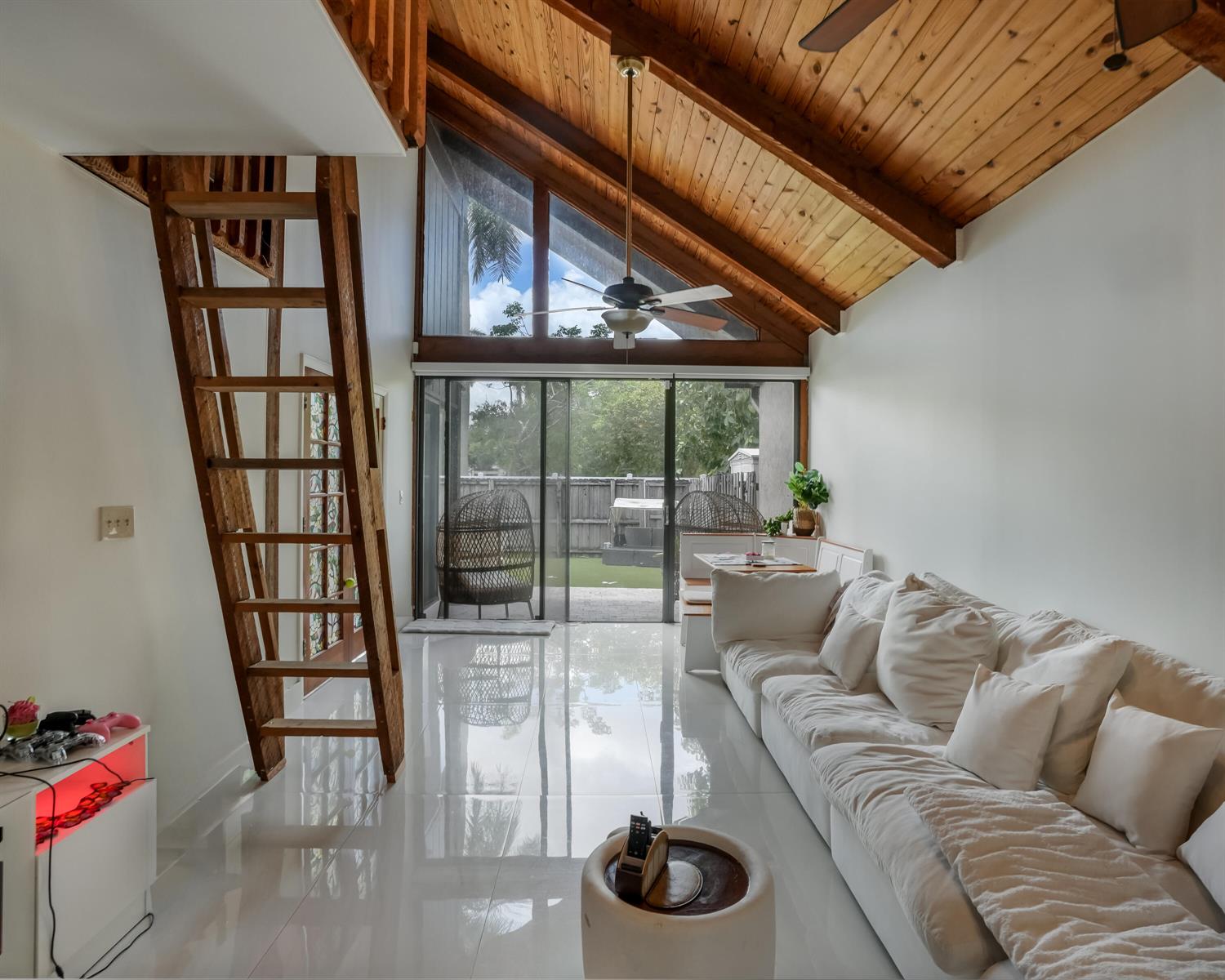 A living room features a vaulted wood ceiling, white tile floors, and a wooden ladder — 407 N University Drive, Plantation FL 33324, PLANTATION, FL