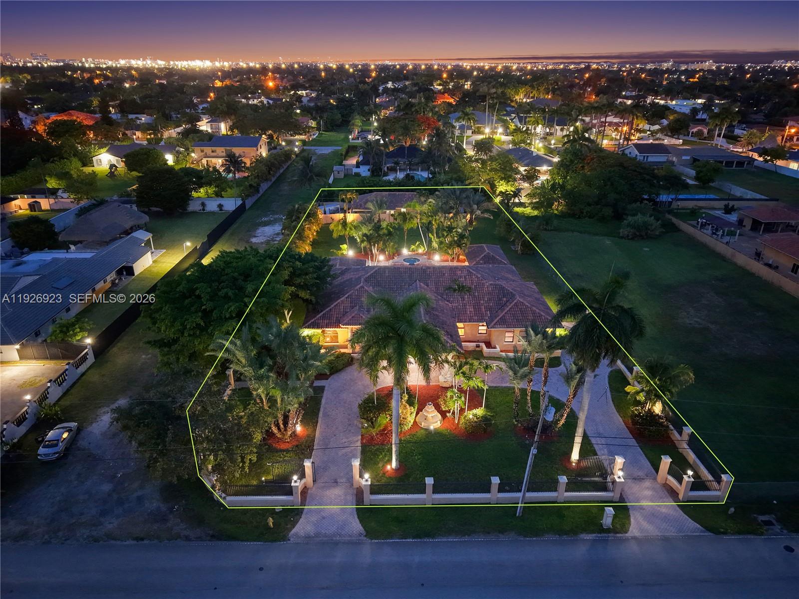 An aerial view at night shows a large house with a circular driveway and landscaping — 3001 SW 132nd Ave, Miami FL 33175, MIAMI, FL