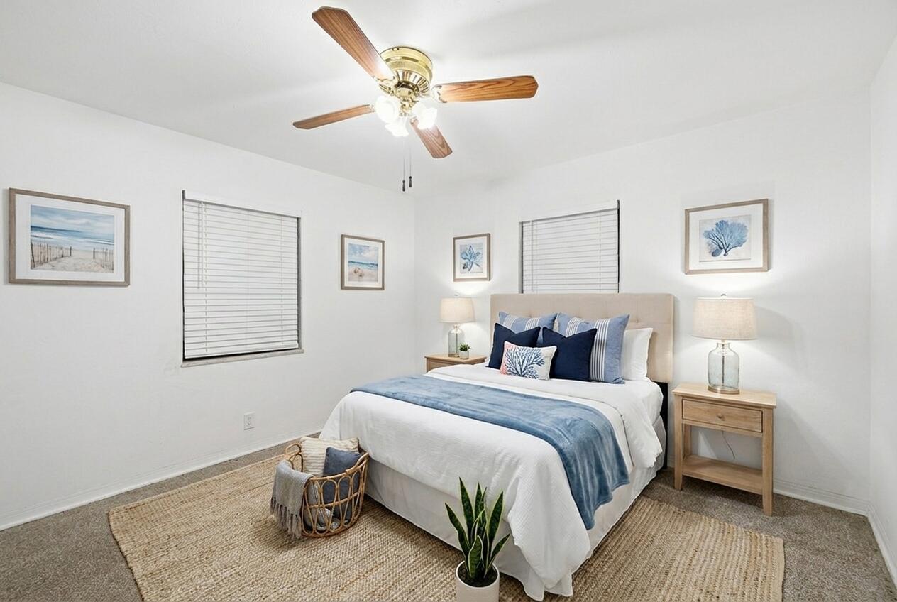 A bedroom features a queen bed, two nightstands, a ceiling fan, and coastal-themed wall art — 1716 N 25th Avenue, Hollywood FL 33020, HOLLYWOOD, FL
