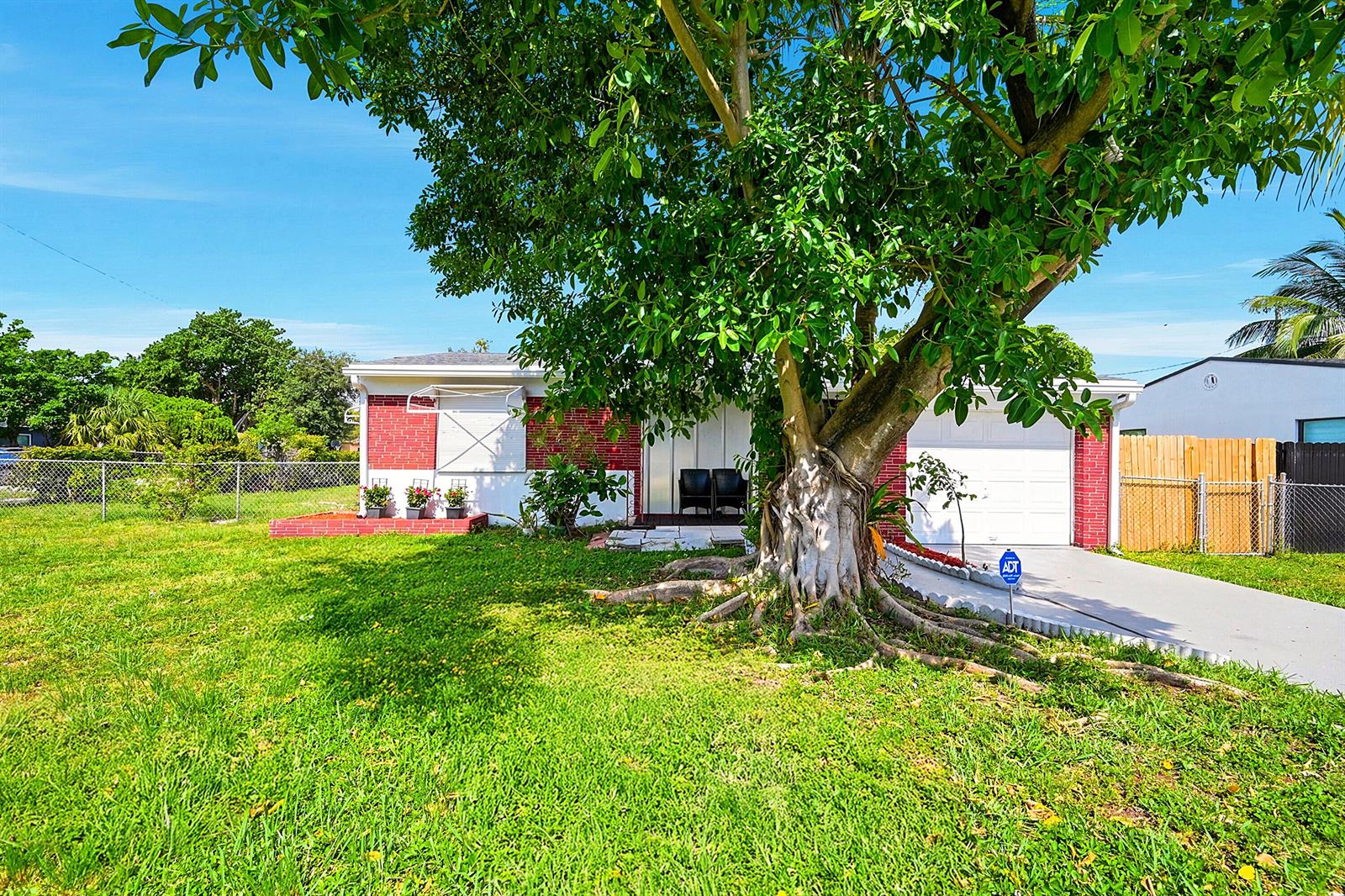 A single-story red brick house with a large tree in the front yard — 1716 N 25th Avenue, Hollywood FL 33020, HOLLYWOOD, FL