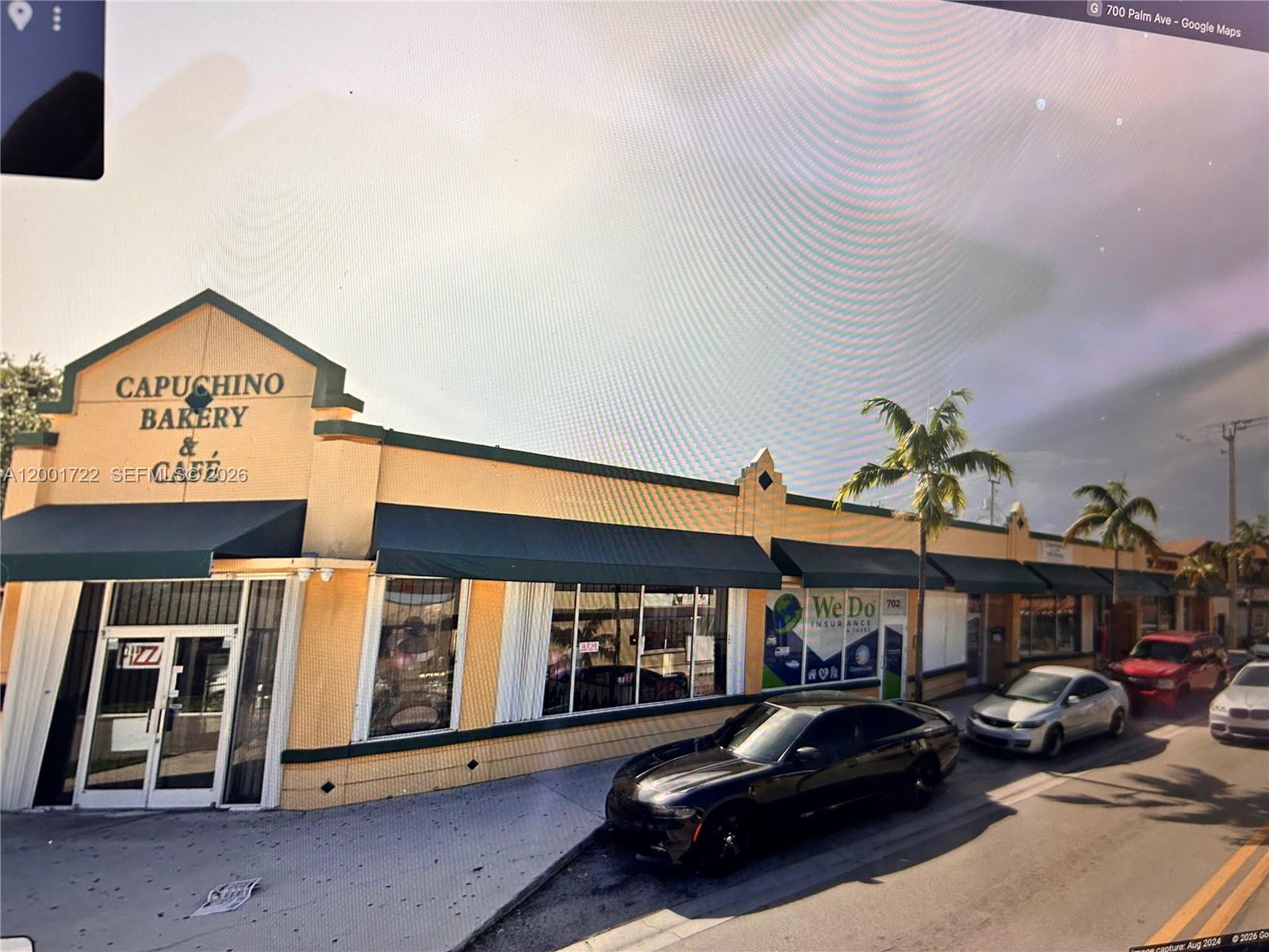 A yellow commercial building with a bakery and insurance office features a green awning — 700 Palm Ave # 702, Hialeah FL 33010, HIALEAH, FL