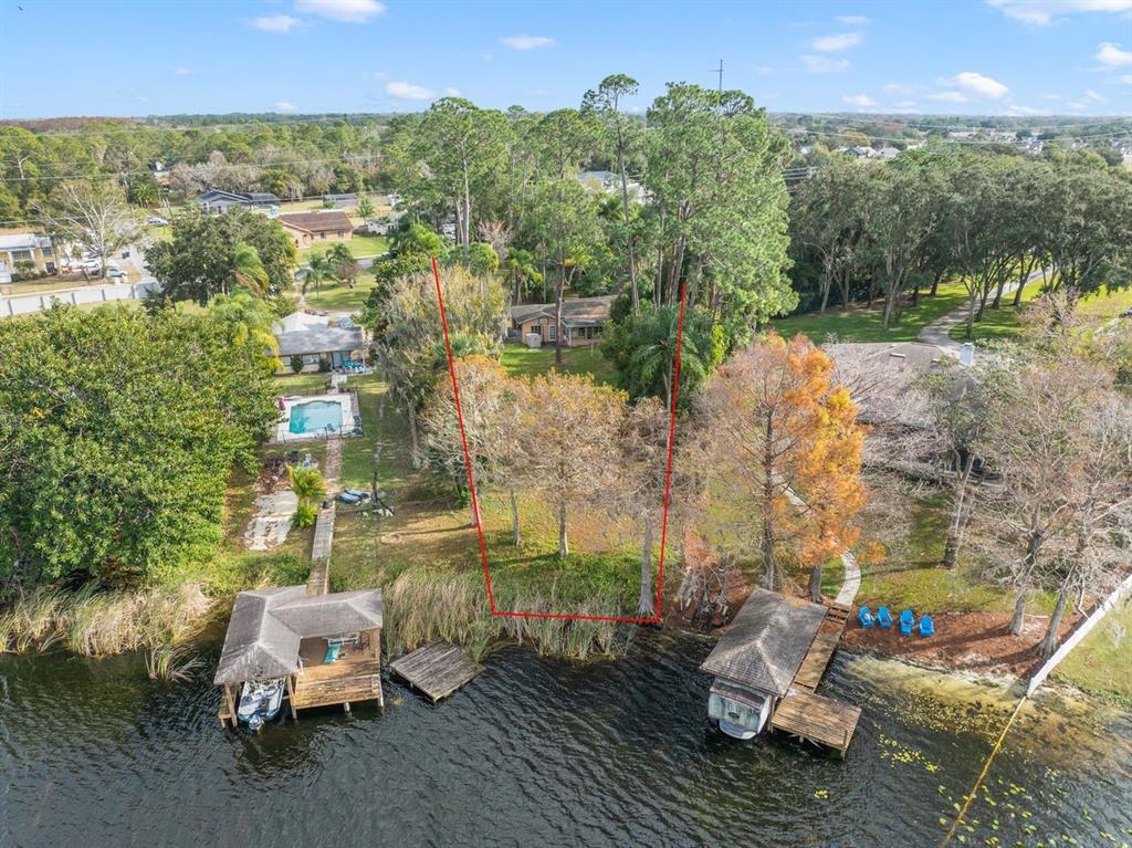 An aerial view shows a waterfront lot with two boat docks and red boundary lines — 3658 N ECONLOCKHATCHEE TRAIL, ORLANDO, FL