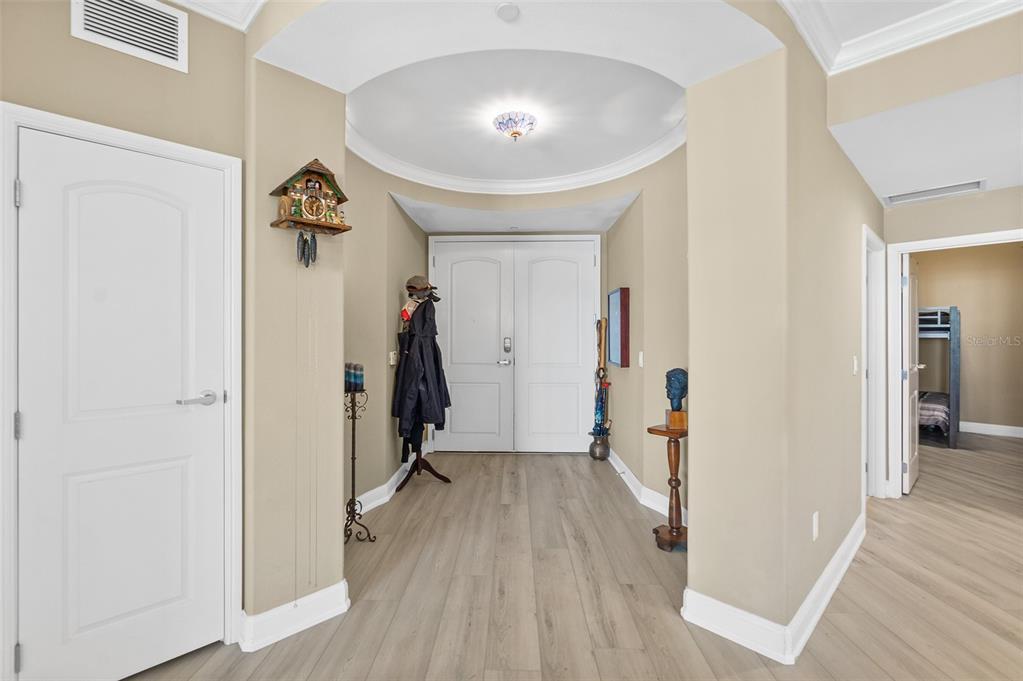 An entryway features a domed ceiling, light wood flooring, and double front doors — 3703 S ATLANTIC AVENUE UNIT 1004, DAYTONA BEACH, FL