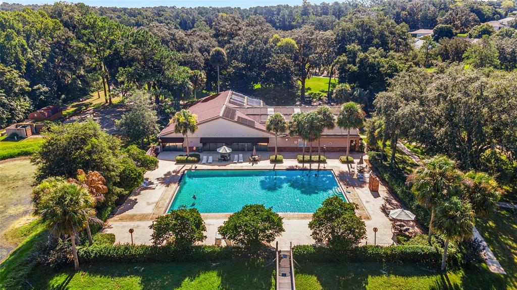 An aerial view shows a rectangular swimming pool with a patio next to a community building — 2656 SW 20TH CIRCLE, OCALA, FL