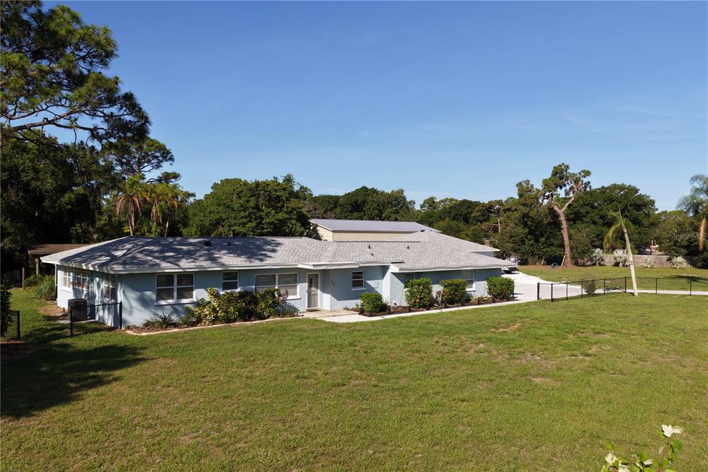 A light blue single-story house with a gray shingled roof sits on a grassy lot — 2746 53RD STREET, SARASOTA, FL