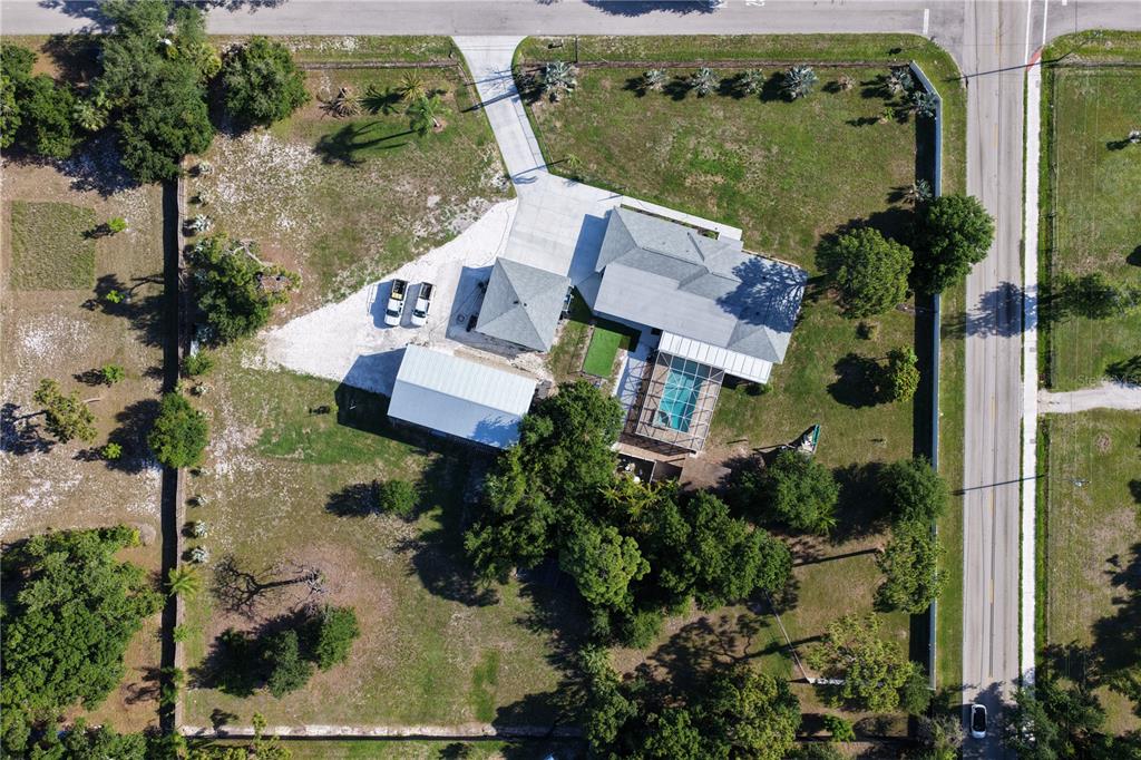 An aerial view shows a house with a pool, detached garage, and large fenced yard — 2746 53RD STREET, SARASOTA, FL