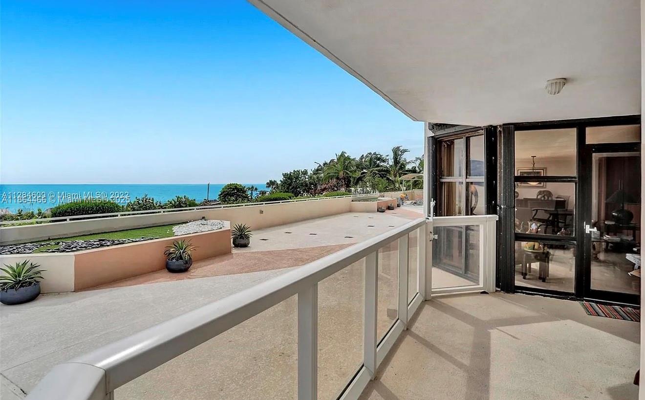 A spacious balcony features a glass railing, concrete flooring, and an expansive ocean view — 6423 E Collins Ave # 206, Miami Beach FL 33141, MIAMI BEACH, FL
