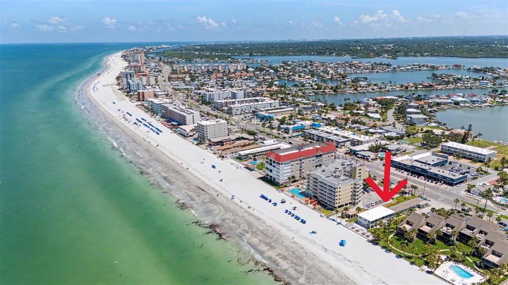 An aerial view of a beachfront property with a red arrow pointing to a building — 16850 GULF BOULEVARD UNIT 4, NORTH REDINGTON BEACH, FL