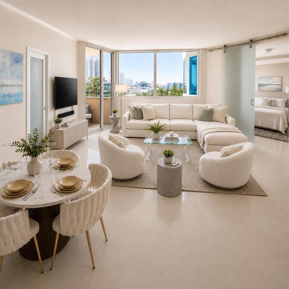 A bright, open-concept living and dining area features modern furniture, a sectional sofa, and balcony — 300 S Pointe Dr # 706, Miami Beach FL 33139, MIAMI BEACH, FL