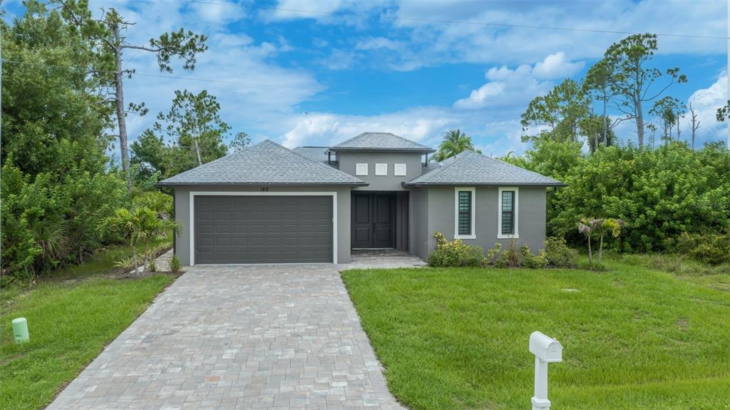 An aerial view shows a residential neighborhood with a red location pin marking a house — 149 WAHOO DRIVE, ROTONDA WEST, FL