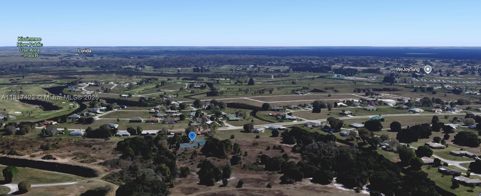 An aerial view shows a residential neighborhood with scattered houses surrounded by open, grassy fields — 1001 Little CT, Sebring FL 33876, SEBRING, FL