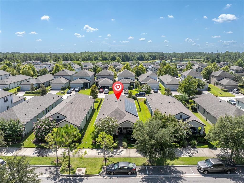 An aerial view shows a suburban neighborhood with a house featuring solar panels — 3794 NIGHT STAR TRAIL, ODESSA, FL