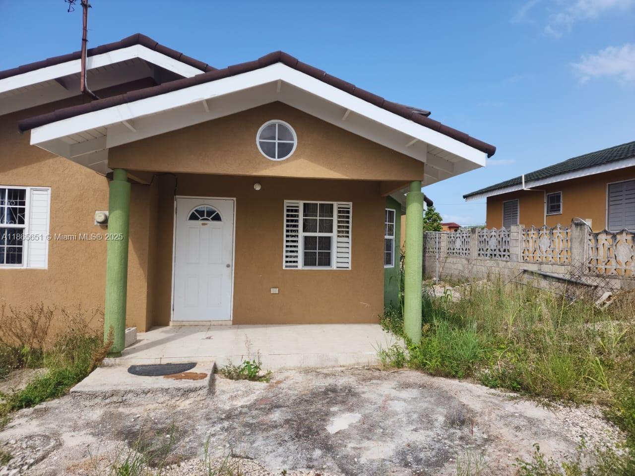 A tan, single-story house features a covered front porch with two green columns — 00 Stonebrook Vista, Trelawny, NA, NA