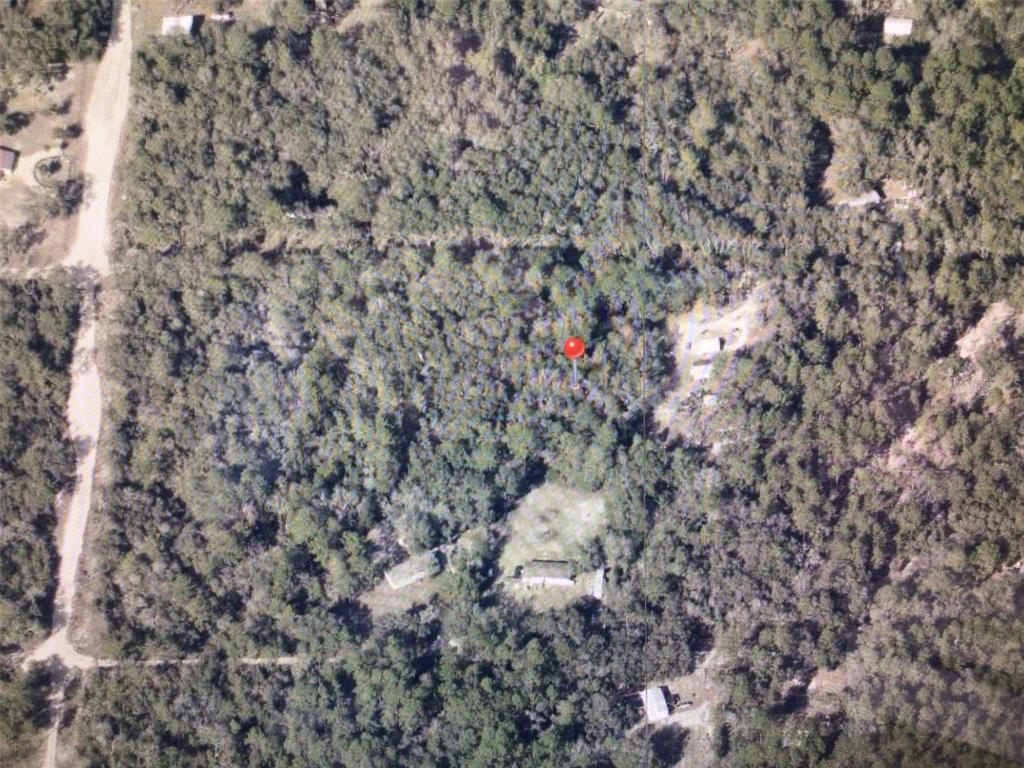 An aerial view shows a wooded lot with a cleared area containing two small buildings — 0 SW 156 PLACE, DUNNELLON, FL