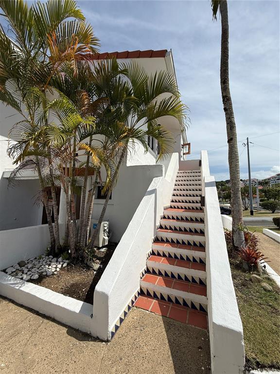 An exterior view of a white building with a tiled staircase featuring decorative blue accents — Cluster 2 6000 RIO MAR BOULEVARD UNIT 5D, RIO GRANDE, PR