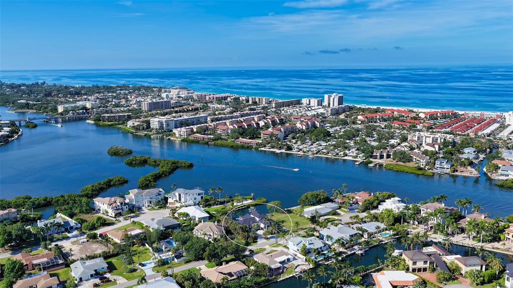 An aerial view shows a residential neighborhood with a circled house near a waterway — 1516 RIDGEWOOD LANE, SARASOTA, FL