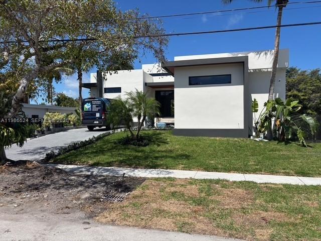 A modern, white single-story house features a flat roof and a dark-colored van parked outside — 2161 NE 124th St, North Miami FL 33181, NORTH MIAMI, FL