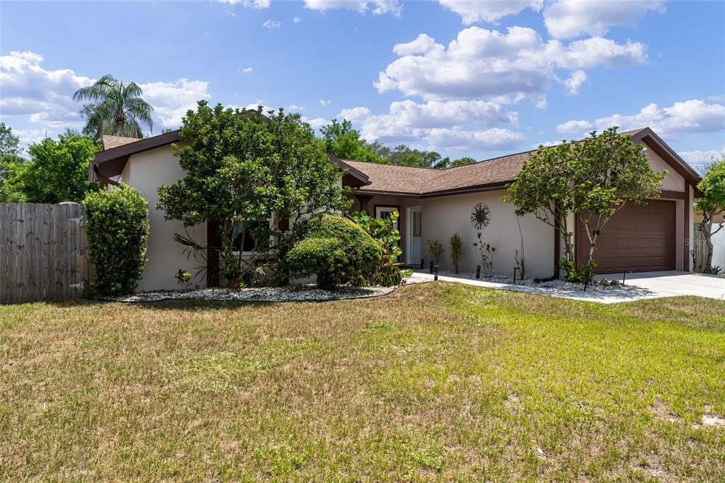 A single-story house with a brown roof, tan exterior, and a two-car garage — 6916 WILLIAMS DRIVE, TAMPA, FL