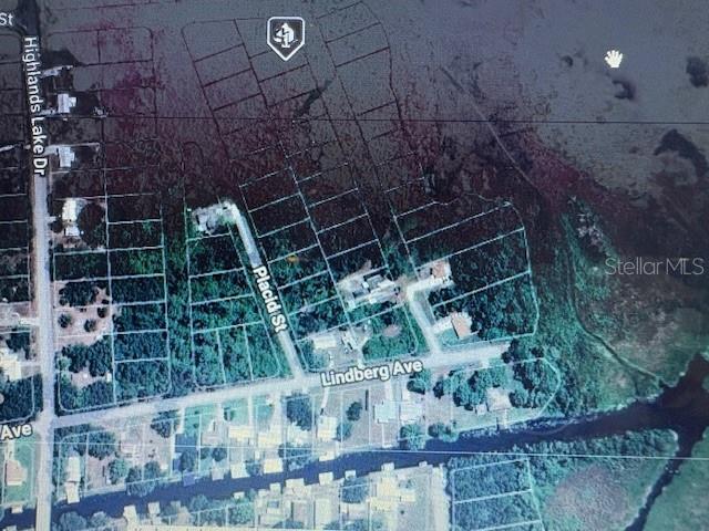 This is an aerial map showing residential lots, streets, and a canal in a wooded area — 744 LAKEMONT DRIVE, LAKE PLACID, FL