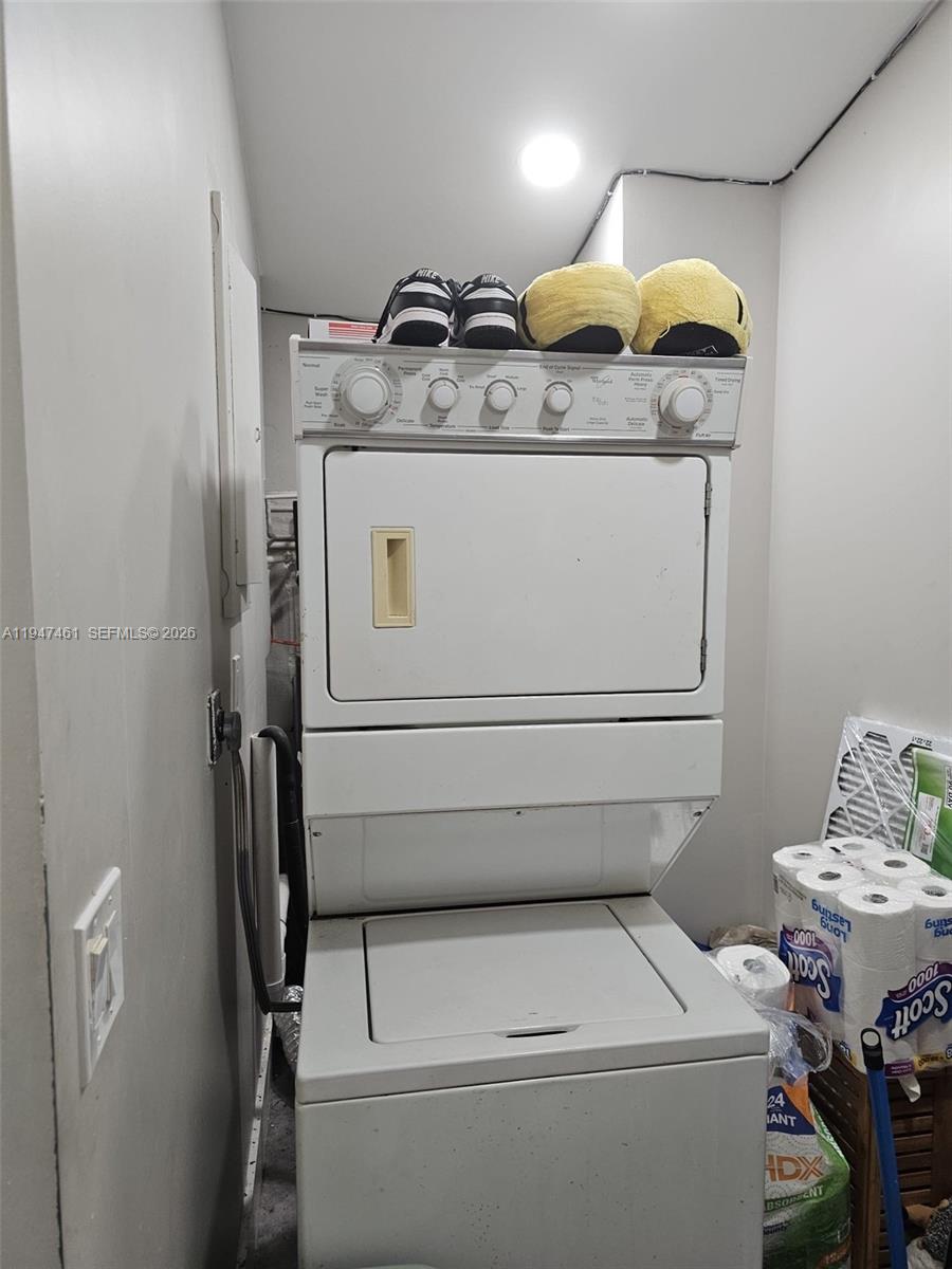 A stacked washer and dryer unit sits in a small laundry closet — 8930 SW 197th Ter, Cutler Bay FL 33157, CUTLER BAY, FL