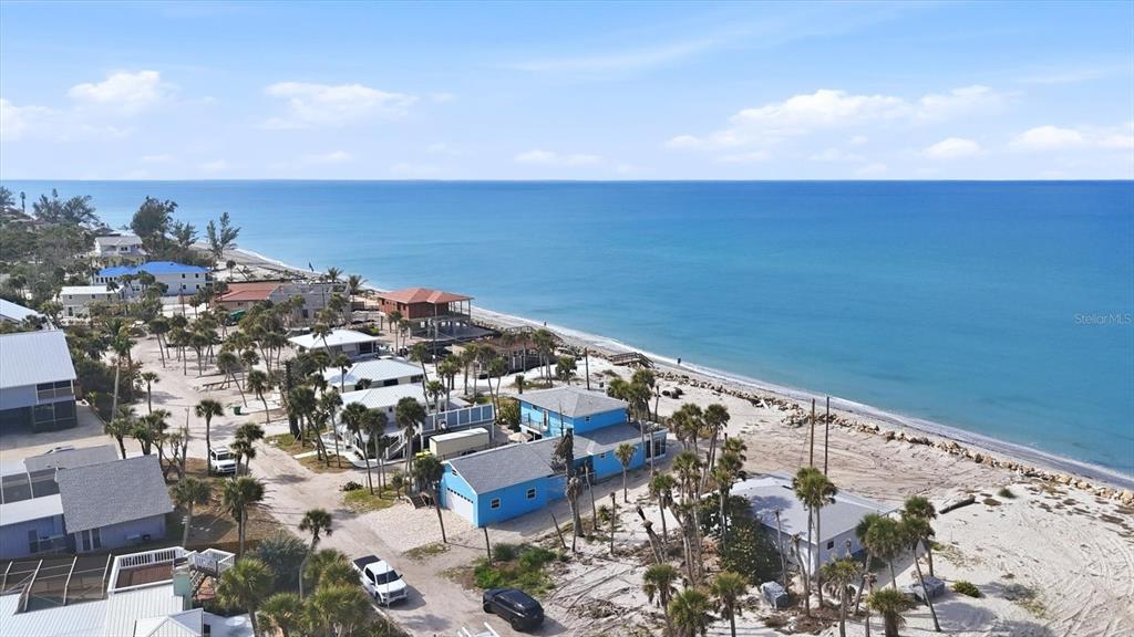 An aerial view of a coastal neighborhood with houses situated along a sandy beach — 4074 N BEACH ROAD, ENGLEWOOD, FL